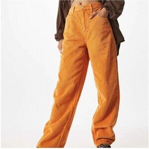 Urban Outfitters BDG High-Waisted Baggy Corduroy Pants in an orange/rust color.